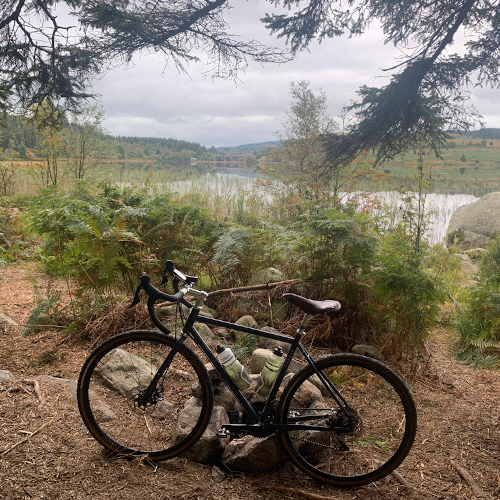 A bike in front of a loch.